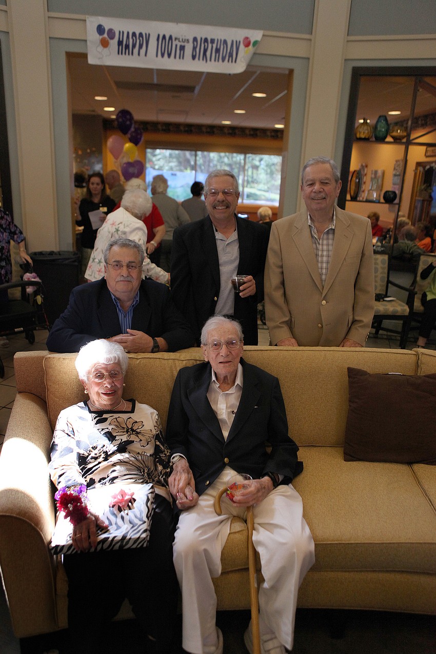Fay Watkins and Maurice Halpern sit while their sons Peter Watkins, David Halpern and Robert Halpern pose behind them, Thursday, April 26, at the Kobernick House.