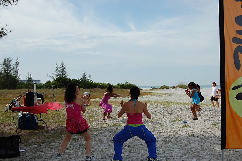 Michelle Davis shows participants that you're never too old to drop it low. The 53-year-old is in the background in pink attire.