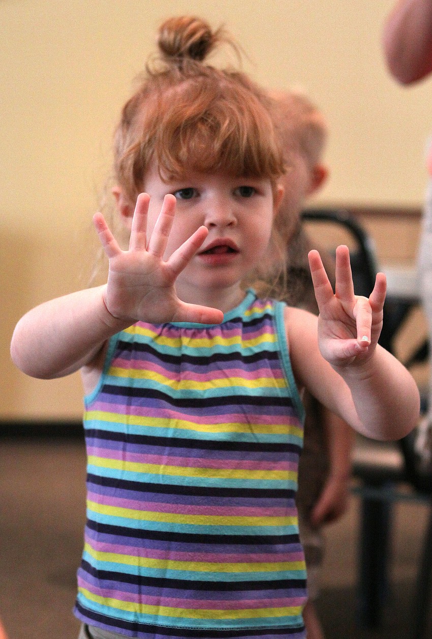 Isla Cawley works on her counting skills during a song in music class.