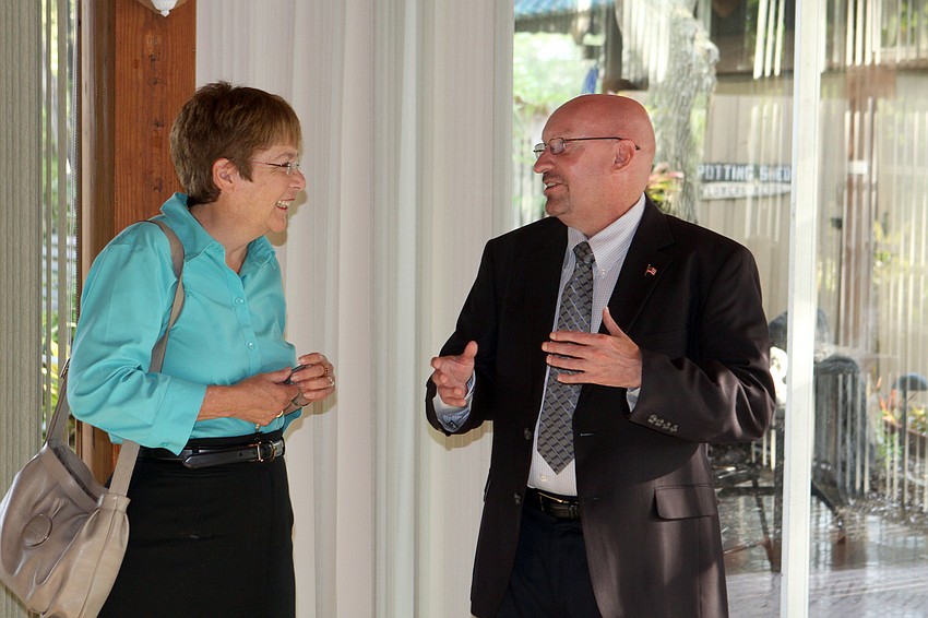 Commissioner Nora Patterson and Brian Slider, Dist. 5, chat with one another, Monday, June 11.
