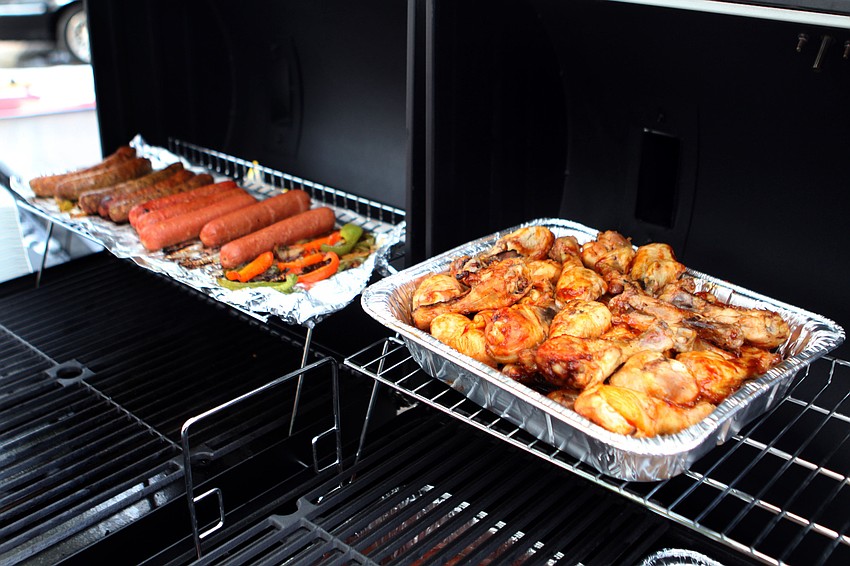 Siesta Key Oyster Bar served up hot dogs, BBQ chicken drumsticks and sausage and peppers as part of a fundraiser for the troops, Wednesday, July 4.