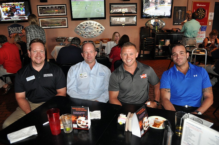 Dean Crowley, Robert Ludwig, Tony Scrimale and Al Billiteri enjoy some food and socialization, Monday, July 9, at the Sarasota Chamber of Commerce event at Findaddy's.
