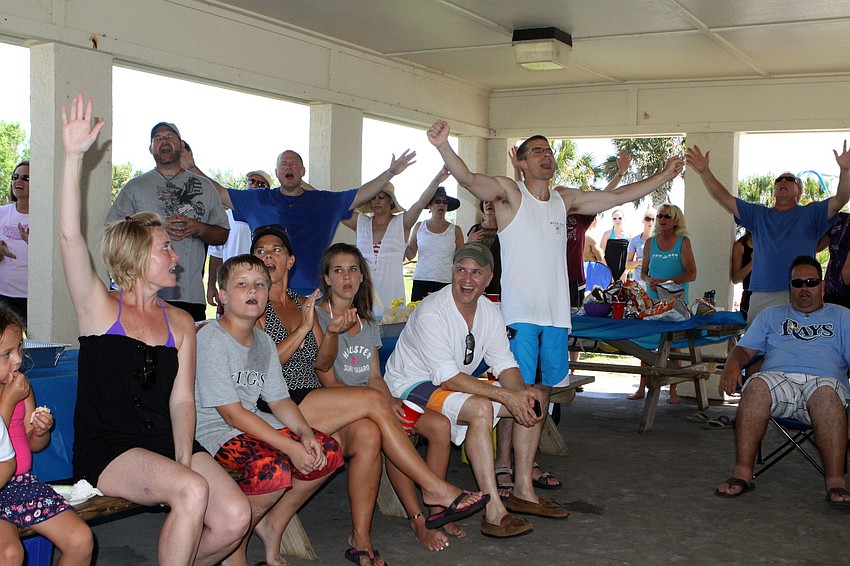 People sing along to worship songs led by worship pastor, Dan Delzer, Sunday, July 30, before the baptism ceremony.