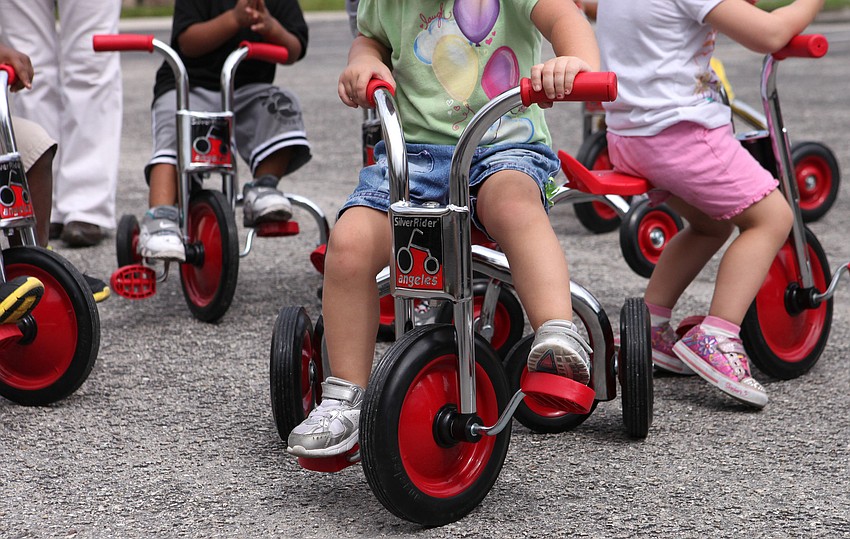 The brand new tricycles donated by the Rotary Club of the Sarasota Bay were a big hit with the toddlers at the Pines.