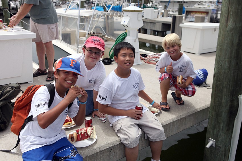 Jacob Petitta, 9, Matthew Fett, 9, Andy Tran, 11, and Lucas Cotton, 10, enjoy their lunches, Wednesday, Aug. 8, after fishing out on the Flying Fish.