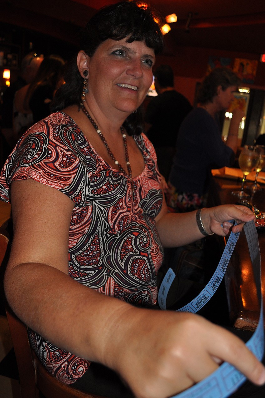 Karen Lange, a cancer survivor, purchased tickets for the auction items.
