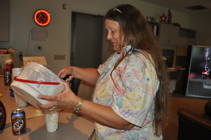 Town Clerk Trish Granger prepares a root beer float for the servicemen
