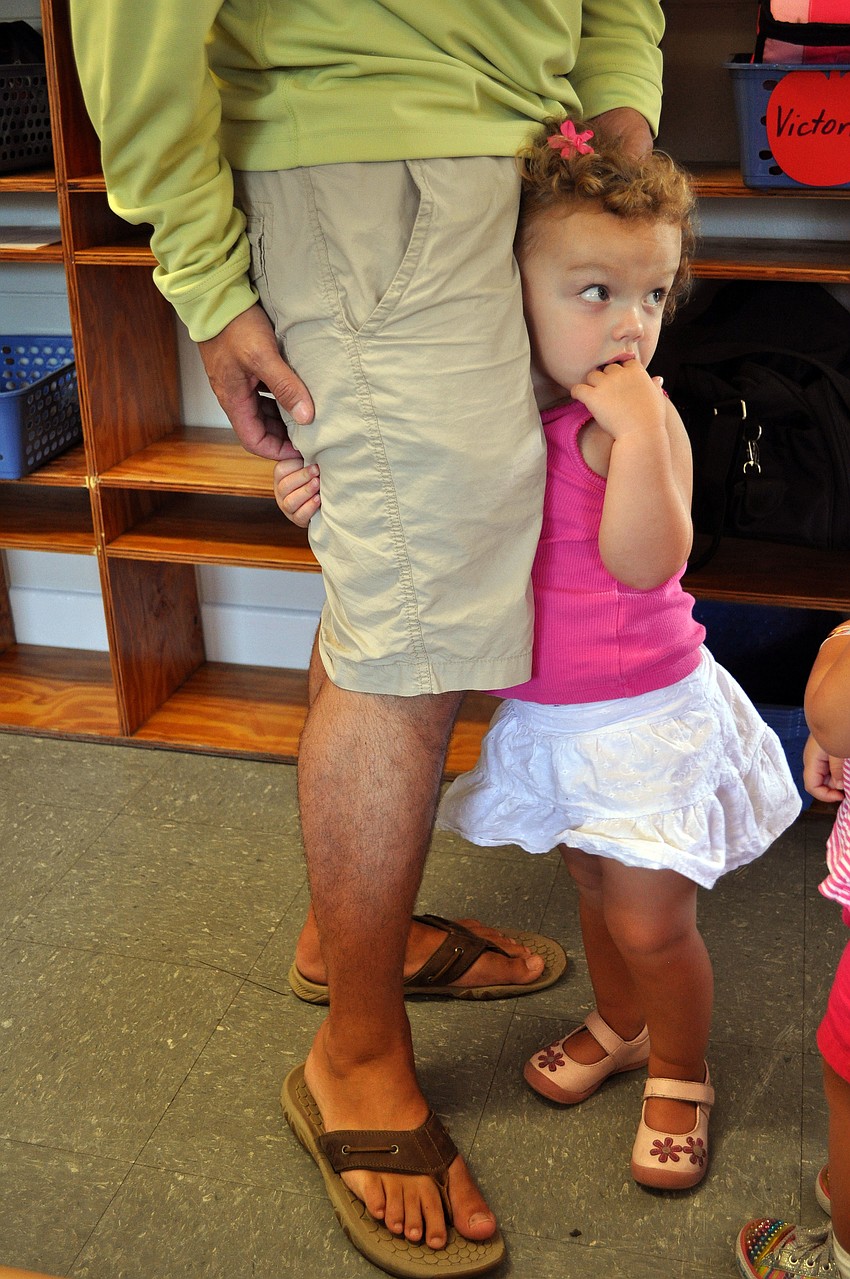 Keira Pritchett, 2, clings to her dadâ€™s, Josh, leg on the morning of the first day of school at St. Boniface Preschool.