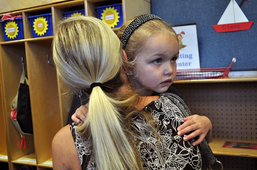 Sophia Paterson, 4, hugs her mom, Monique, goodbye, Wednesday, Aug. 22, as she begins her first day of school at Out-of-Door Academy.