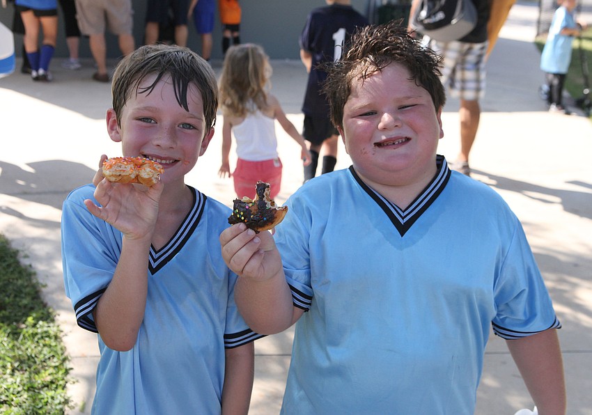 Zachary Westover, 6, and Reece Dentici, 6, enjoy donuts after playing their game Saturday, Sept. 8 at Glebe Park.