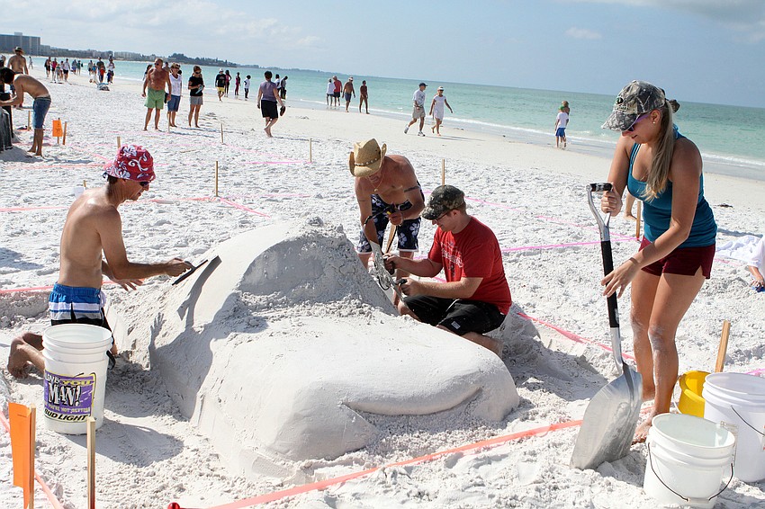 Ricky Arey, Jay Bush, Chris Goosney and Holly Arey work on their creation â€œLightningâ€.