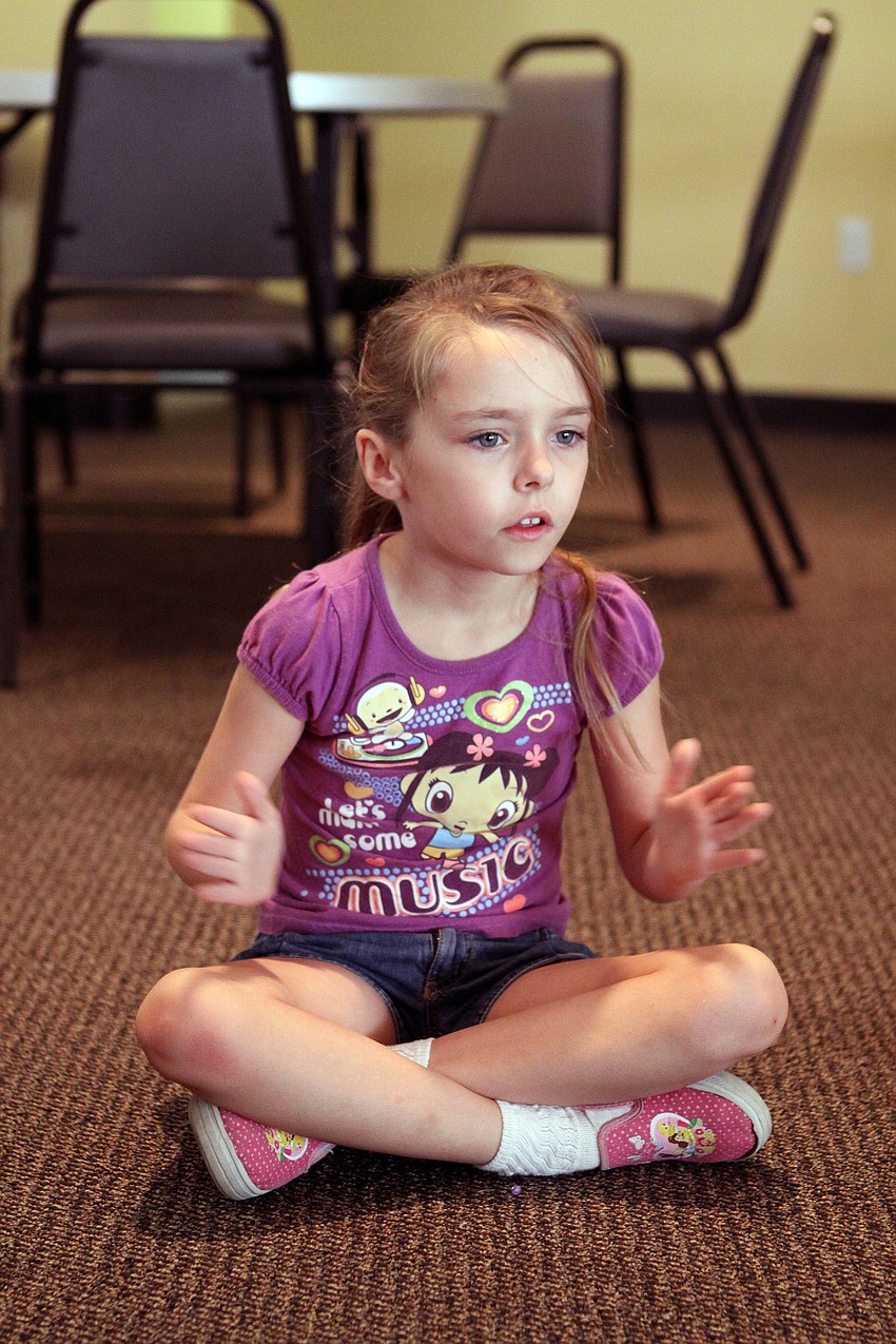 Linda Hayes claps her hands together during a song, Wednesday, May 9.