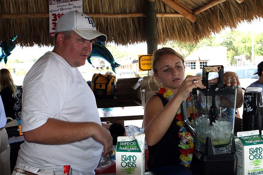 Eoin Farrell and Alexis Sulentic work on making a margarita, Sunday, May 27, during the grand opening of the Chickee Bar.