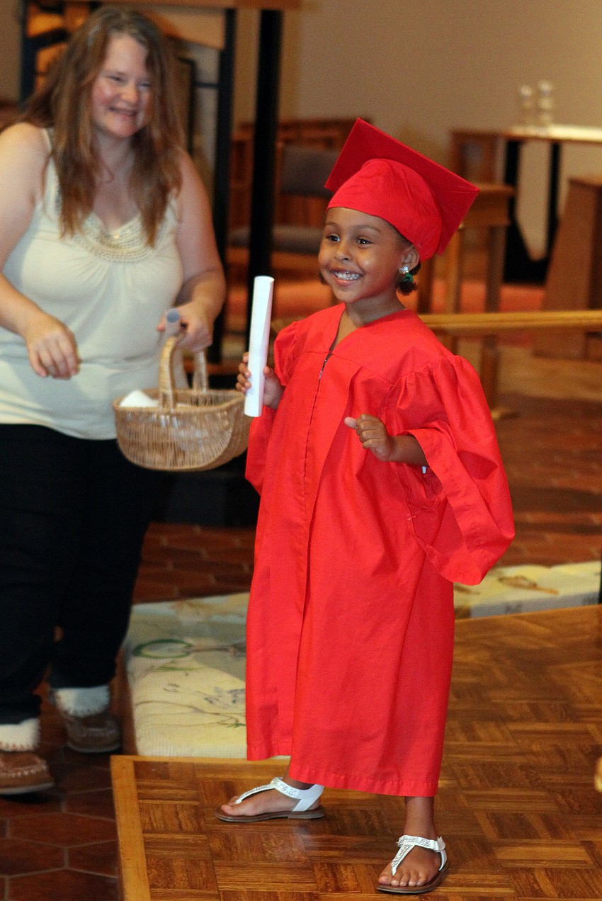 Francesca Magnotti smiles proudly after receiving her diploma.