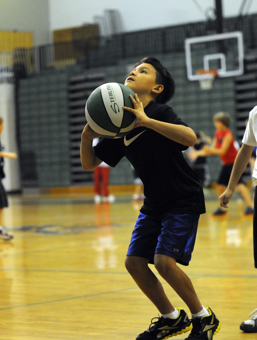 Eight-year-old Sean Sugamura practices his shooting.