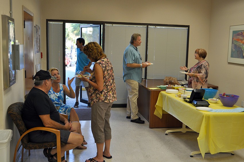 Church members converse at the open house.