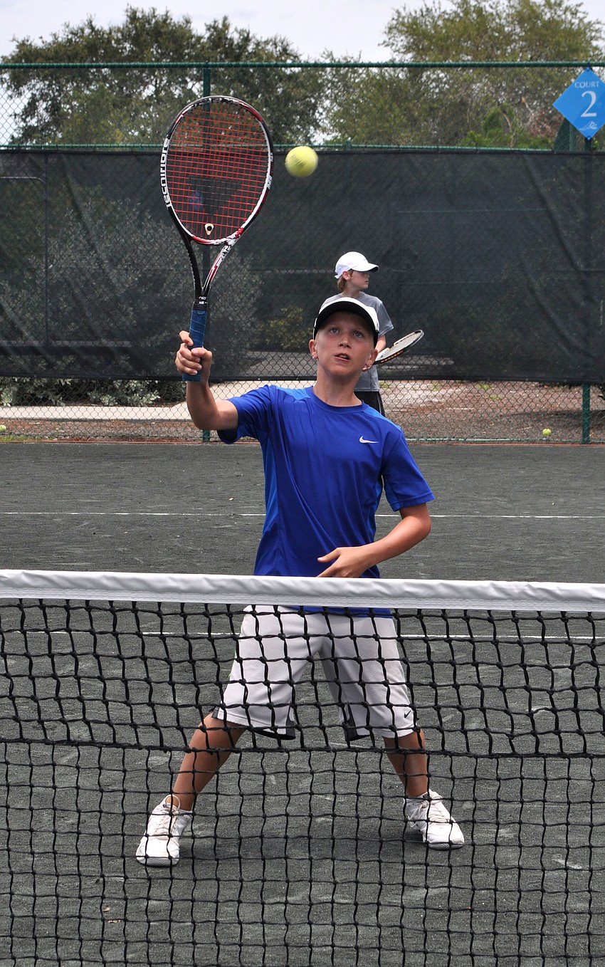 Stefan Stanczuk, 12, goes for a forehanded volley.