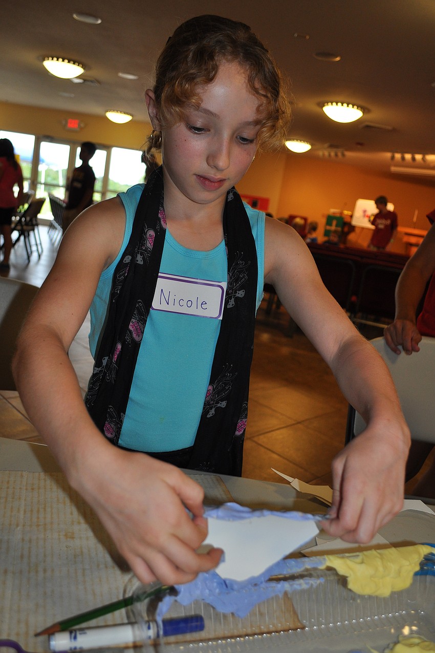 Nicole Ouellette, 9, wanted her heart to be completely blue when it dried.