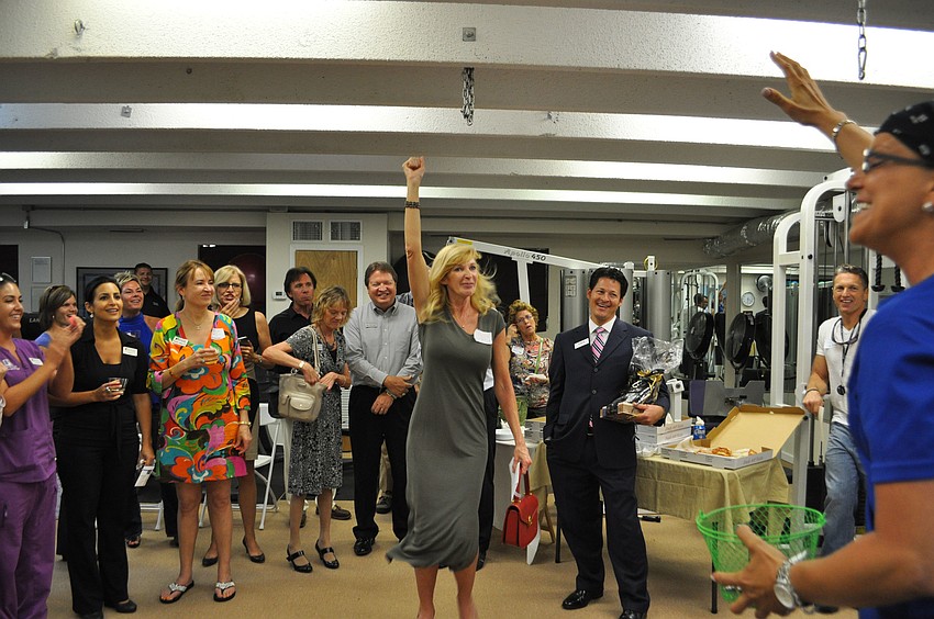 Virginia Harshman celebrates as her name is drawn.