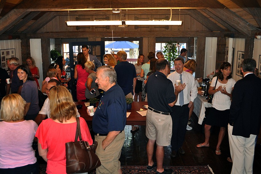 Parents and staff gather in the cabin to chat, drink coffee and sign up to help with school events throughout the year, Wednesday, Aug. 22, at Out-of-Door Academy.