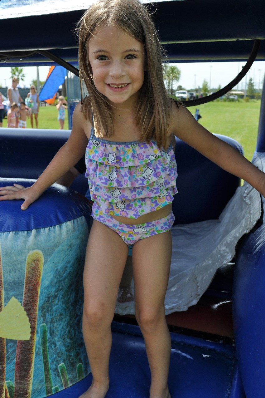 Ashley Olah, 5, managed to stay dry while making her way down the slip-and-slide tunnel.