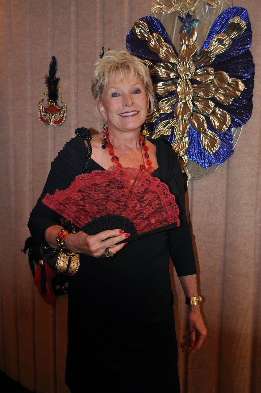 Judy Harms with her festive red and black fan.