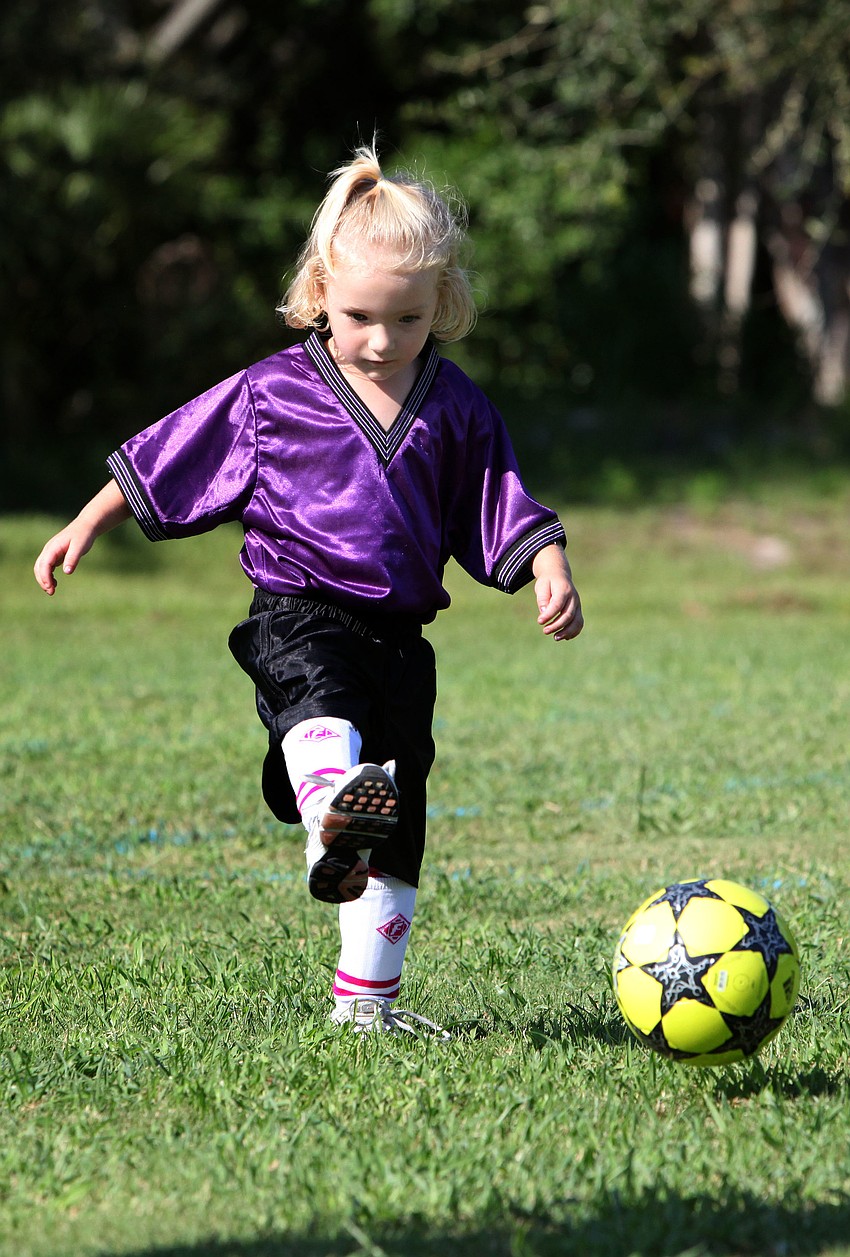 Lily Wicks, 3, practices kicking the ball prior to playing her first soccer game Saturday, Sept. 8 at Glebe Park.