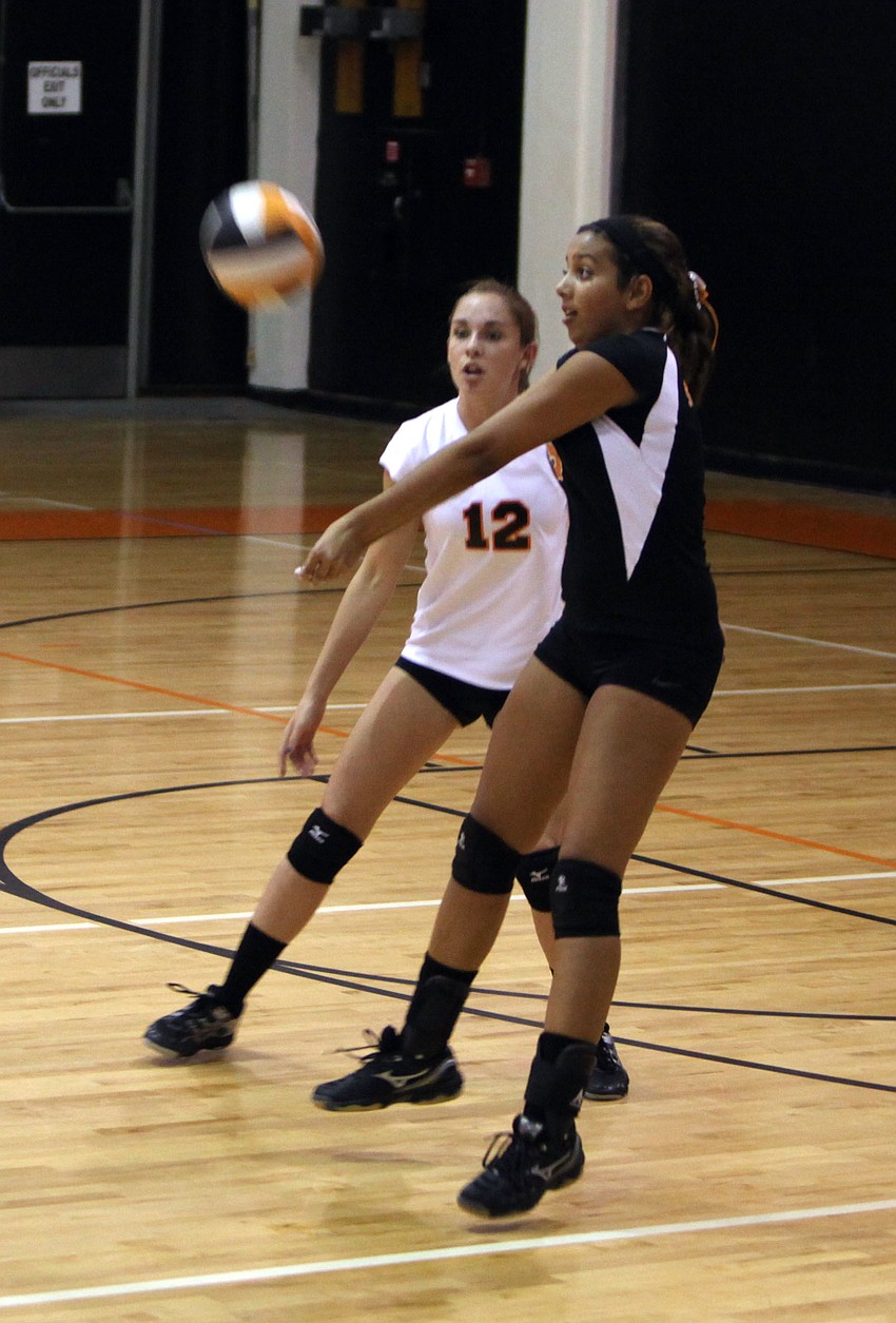 Gabby Diaz, No. 5, bumps the ball as her teammate, Jordan Brooks, No. 12, stays close by during the Cardinal Mooney versus Sarasota High School game Tuesday, Sept. 11 at Sarasota High School.