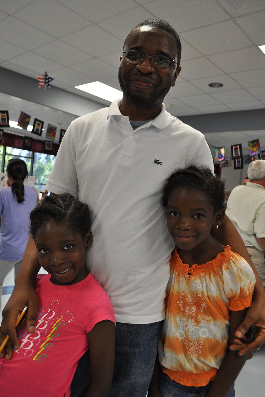 Kay Somefun, center, came out with his daughters, Danielle, left, and Moyo, right.