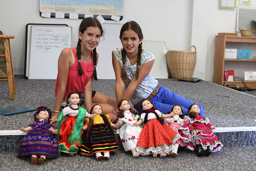 Karen Orozco, 12, and Julia Bulle, 12, pose with the dolls they brought from LÃ©on, Mexico.