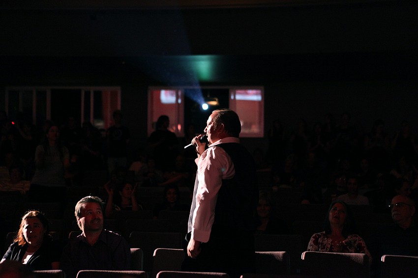 JJ Midnight makes his way through the audience during his performance with the Bohemian Rhapsody Orchestra, Thursday, April 26, at the Riverview High School Performing Arts Center.