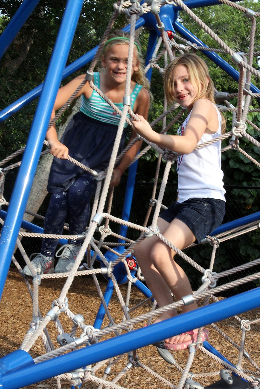 Ava Krug, 6, and Eden Harris, 6, have climbing on the â€œspiderâ€.