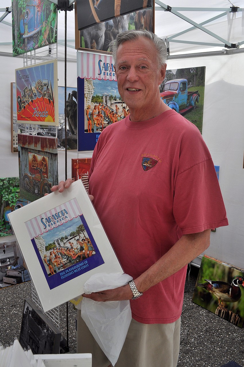 Bill Cone shows off the print he bought from Daniel Baldwin Photography, Saturday, May 19, at the 9th Annual Downtown Sarasota Craft Festival.