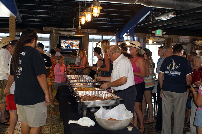 People enjoyed the free food offered during the grand opening of the Chickee Bar at Waltâ€™s Fish Market, Sunday, May 27.