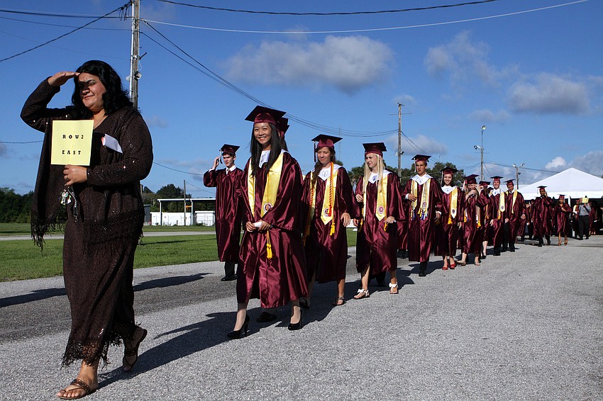 Students walk over to Robarts arena as they prepare to graduate, Saturday, June 2.