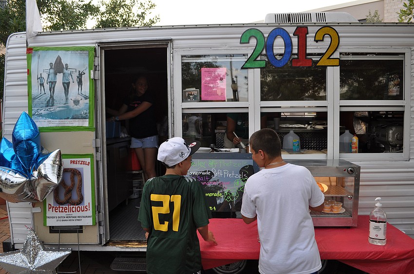 Two boys wait to get a snack at the Pretzelicious stand.