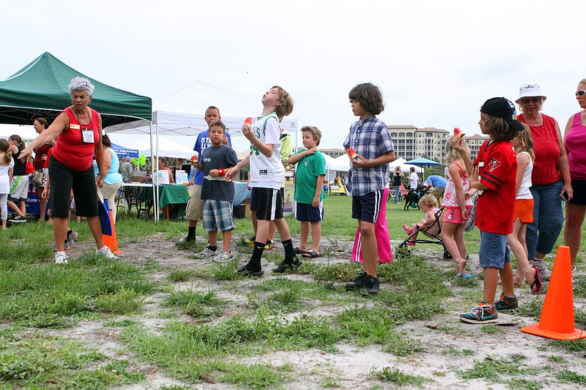 Boys try their hand at spitting watermelon seeds, Wednesday, June 6.