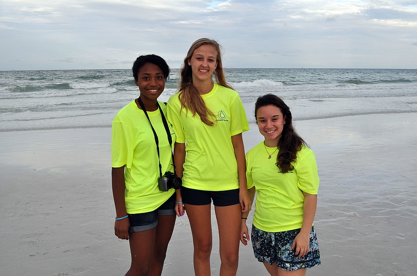 Rose Savwoir, 14, Adrianne Stolpe, 14, and Alicia Ramirez, 15, all helped out at the 5K, Saturday, June 9, on Siesta Key Beach.