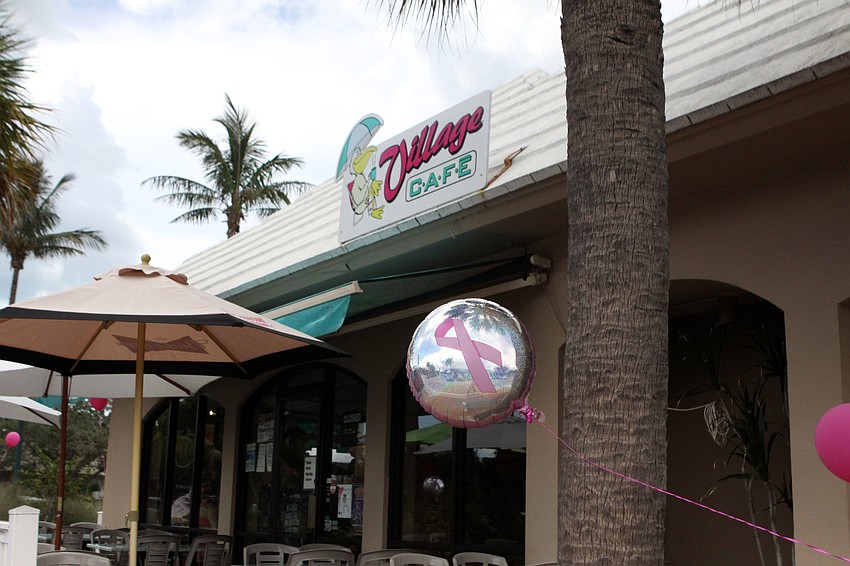 Pink and pink ribbon balloons blew around in the wind outside of Village CafÃ©, Saturday, July 14, during the Drink Pink event.