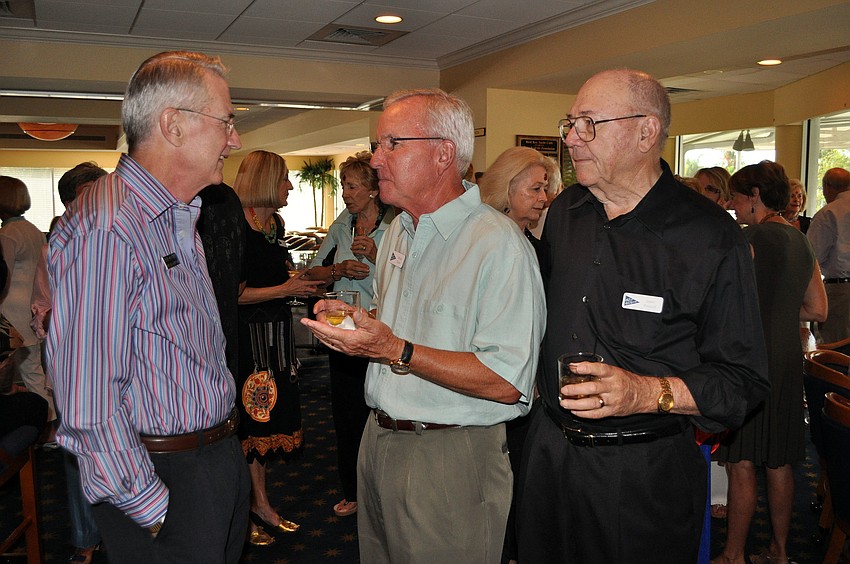 Commodore Bob Hunter, former commodore David Taylor and former commodore Jamo Powell talk to one another, Saturday, July 21, at Bird Key Yacht Club.