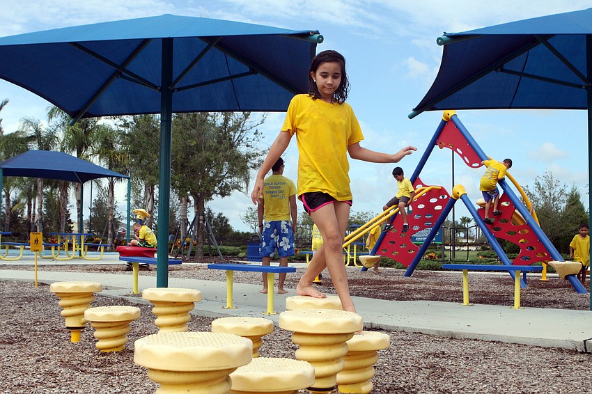 Ruthann Mazzullo, 10, walks across the uneven, plastic stepping stones.