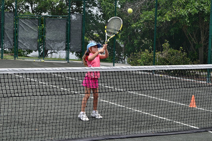 Clementine Schwartz, 7 Â½, hits a backhanded volley.