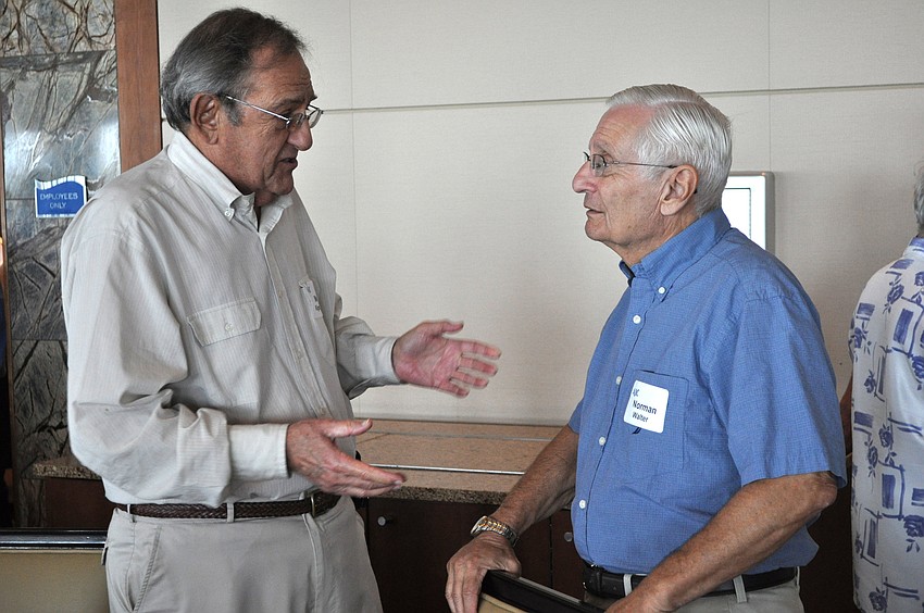 Mel Klingman and Norman Walter chat before the beginning of the AJCâ€™s Summer Lunch & Learn talk, Wednesday, July 25, at Sarasota Yacht Club.
