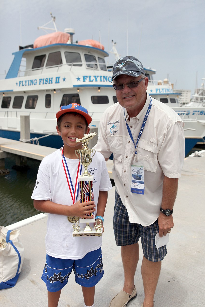 Jacob Petitta won the trophy for catching the â€œugliest fishâ€, a porcupine puffer fish.