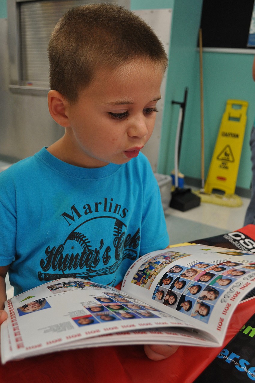 Landon Robertson, 6, checked out school yearbooks with his big brother, Logan, a student at Lakewood Ranch High.