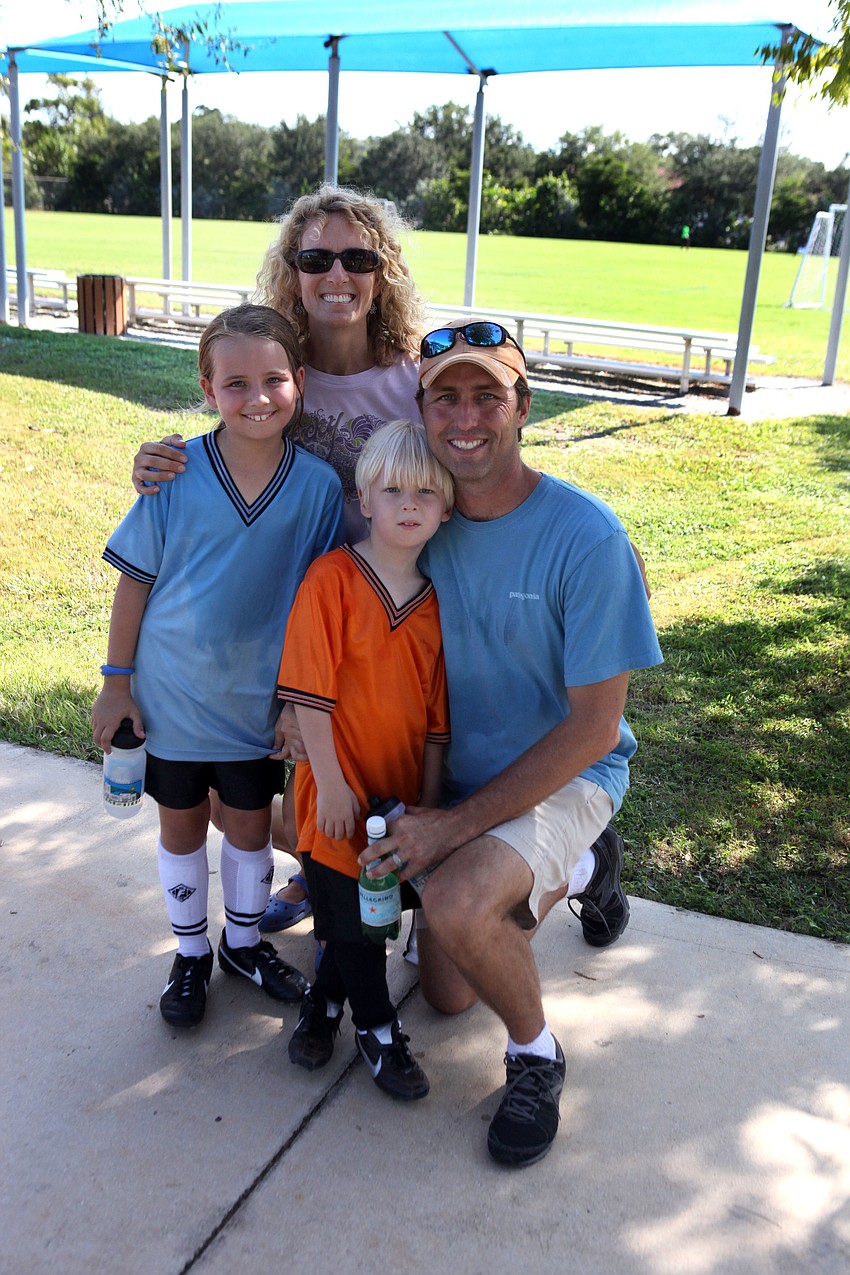 Laura and Travis Yates pose with their daughter, Hannah, 9, and son, Luke, 5, following their first games of the Suncoast Sports Club season Saturday, Sept. 8 at Glebe Park.