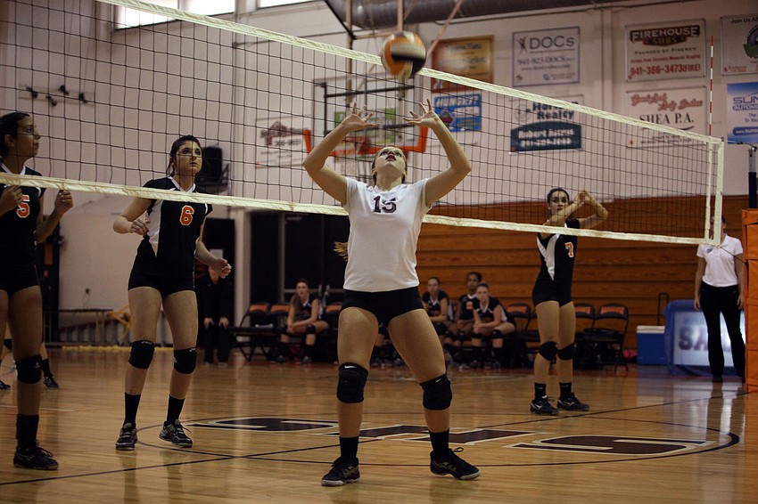 Maddy Del Medico, No. 15, sets the ball to go back over the net Tuesday, Sept. 11 during the Cardinal Mooney versus Sarasota High School JV volleyball game at Sarasota High School.