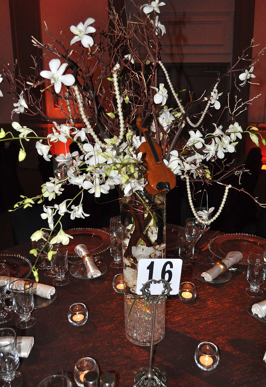The centerpieces were decorated with pearls and a miniature violin.
