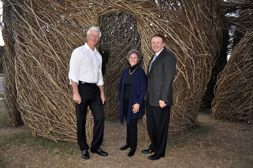 Patrick Dougherty with Wendy Surkis and Dr. Larry Thompson in front of the stick sculpture.