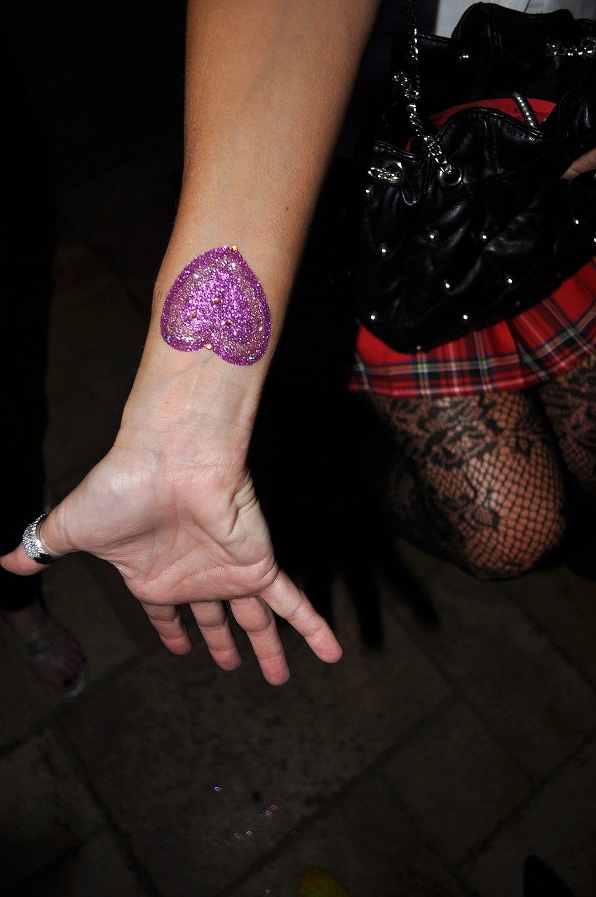 Susan Jones shows off her glitter, heart tattoo.